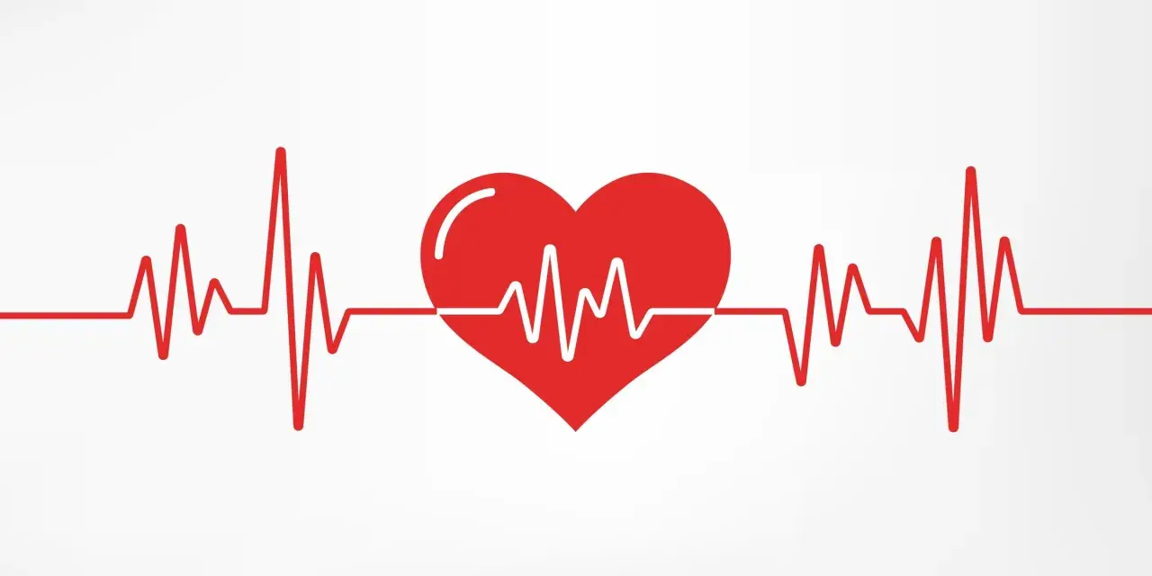 Czerwone serce z linią EKG na białym tle.