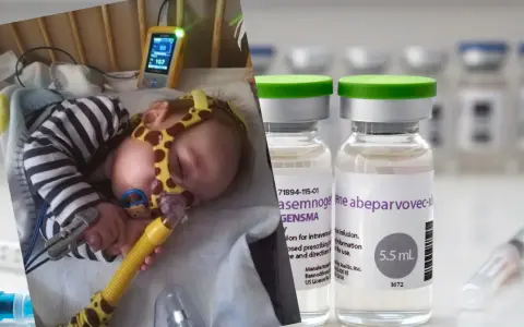 Chore niemowlę podłączone do aparatury medycznej obok fiolek z lekiem.